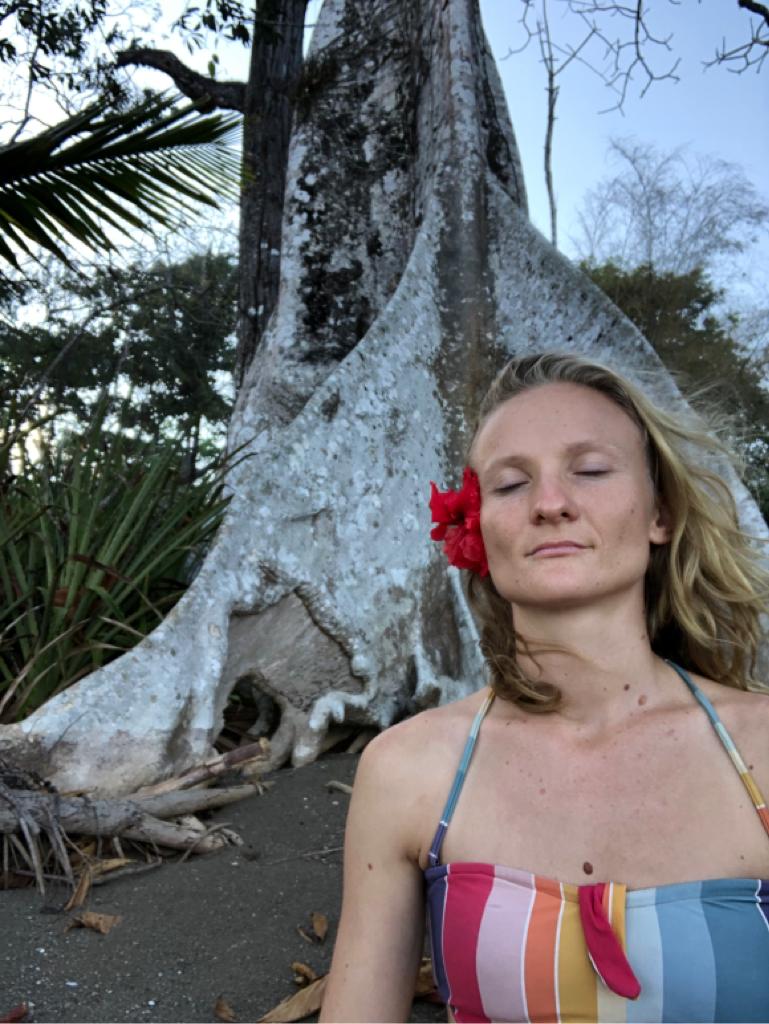 Naïma con los ojos cerrados junto a un árbol